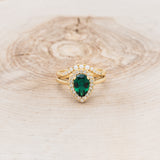 "ARABELLA" - PEAR-SHAPED LAB-GROWN EMERALD ENGAGEMENT RING WITH DIAMOND ACCENTS & PEARL TRACER