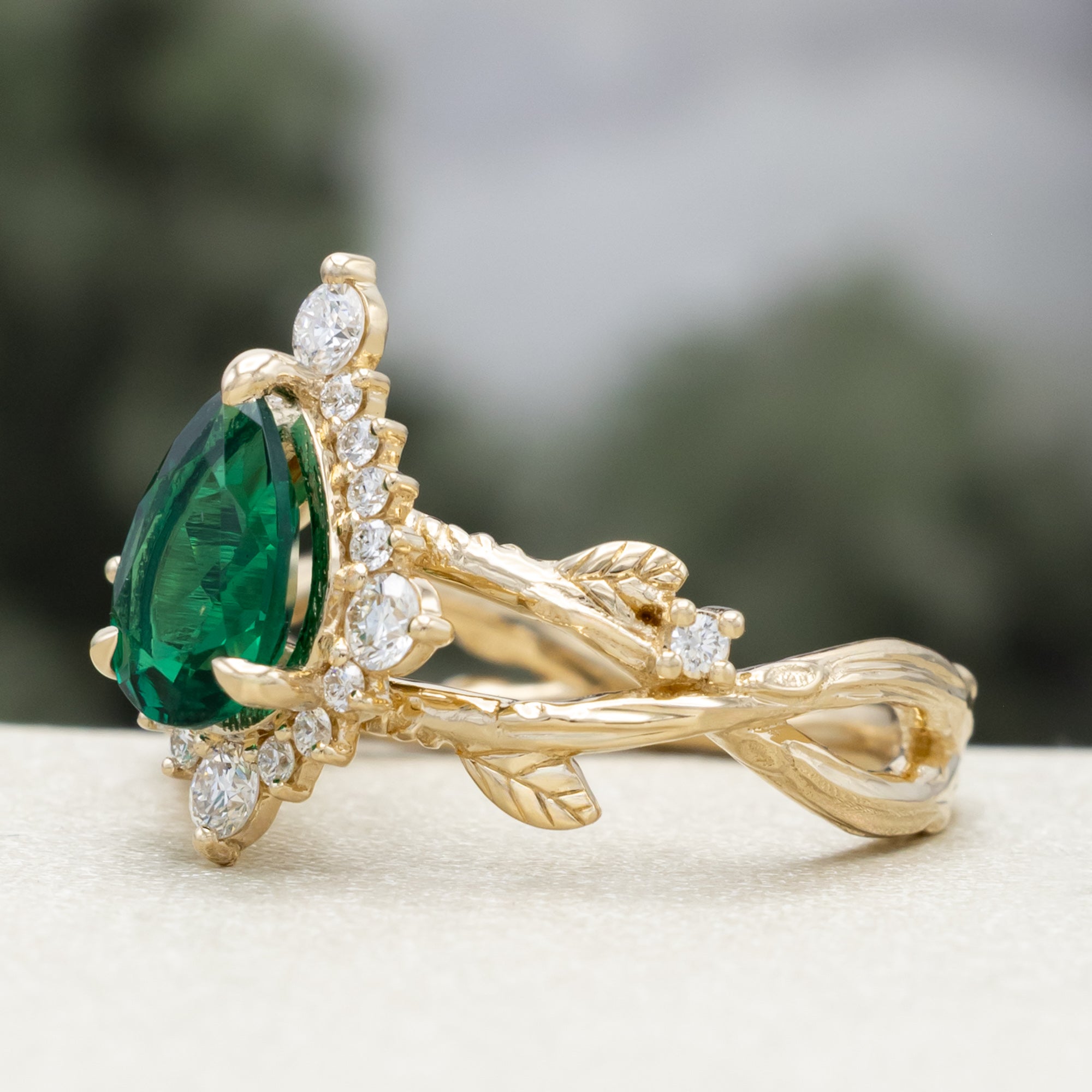 "ARTEMIS ON THE VINE DIVINE" - PEAR CUT LAB-GROWN EMERALD ENGAGEMENT RING WITH DIAMOND ACCENTS & A BRANCH-STYLE BAND-Staghead Designs