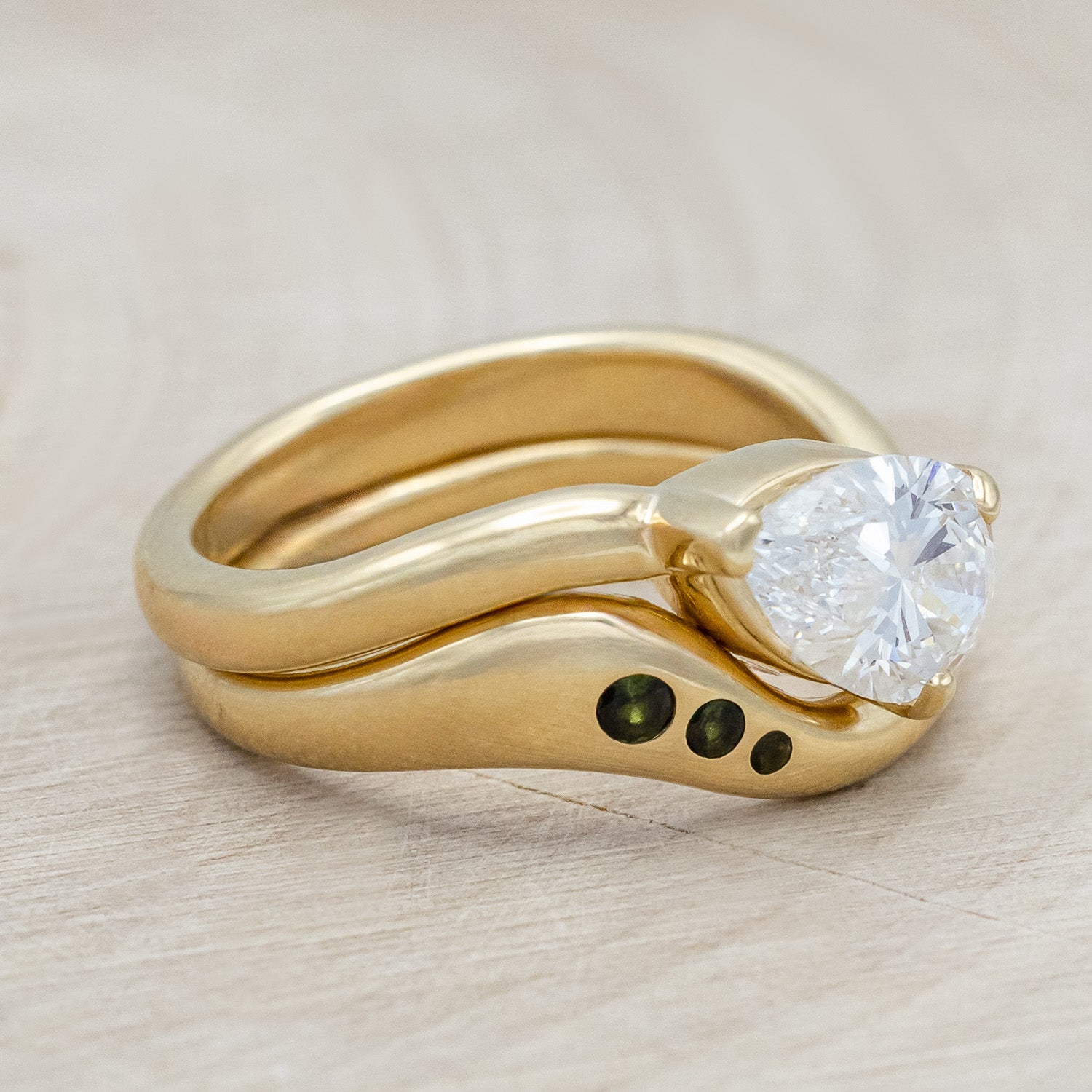 Side view of "Sybil" - asymmetrical solitaire-style lab diamond women's engagement ring with green tourmaline tracer