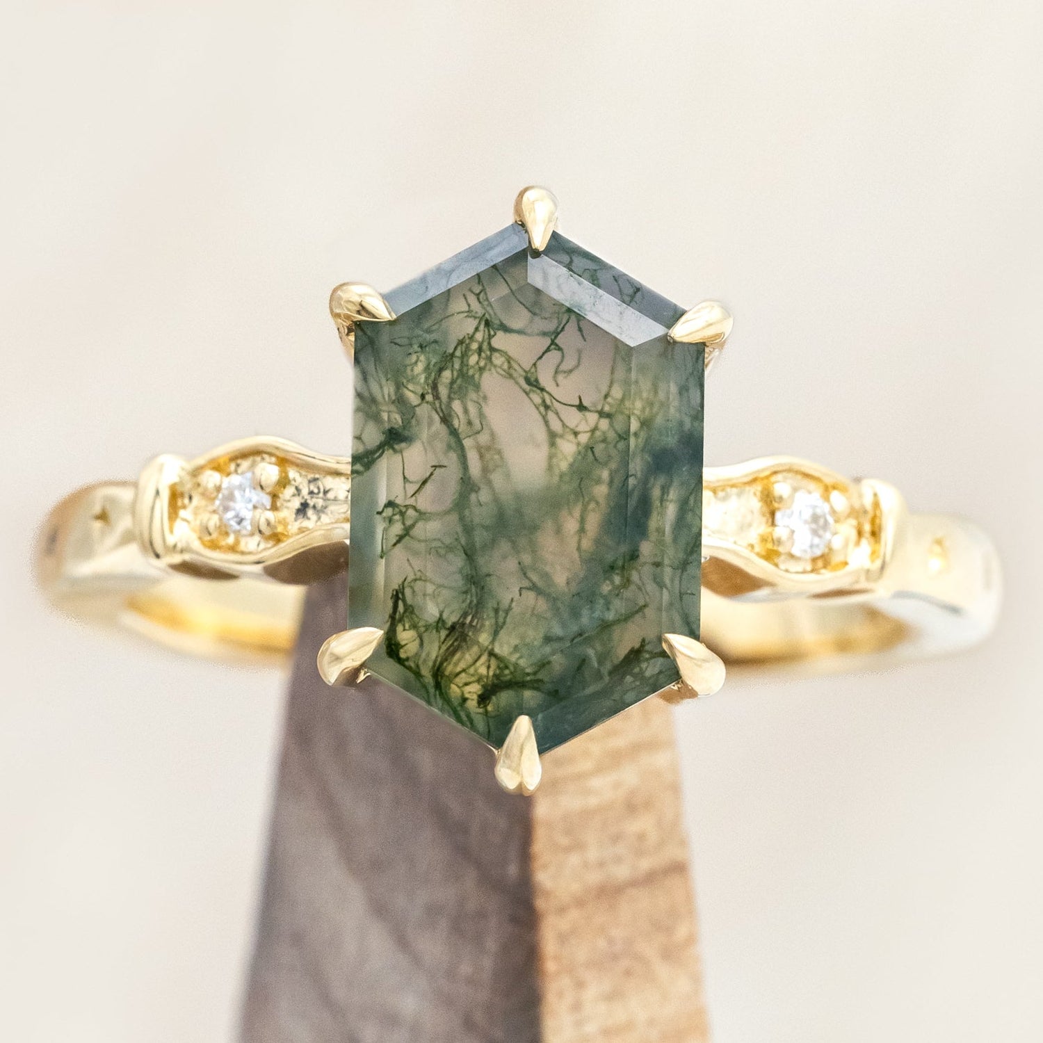 14K gold ring with moss agate with diamond accents on a neutral background