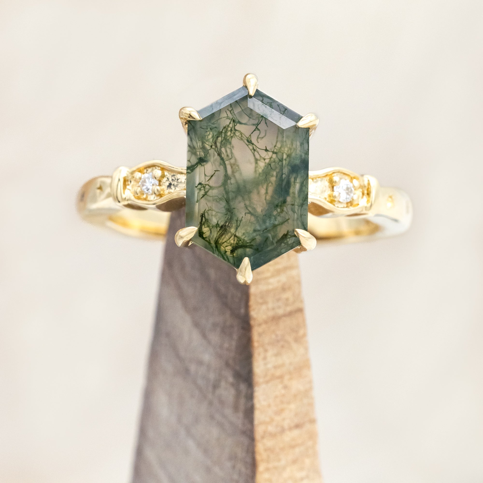 14K gold ring with moss agate with diamond accents on a neutral background