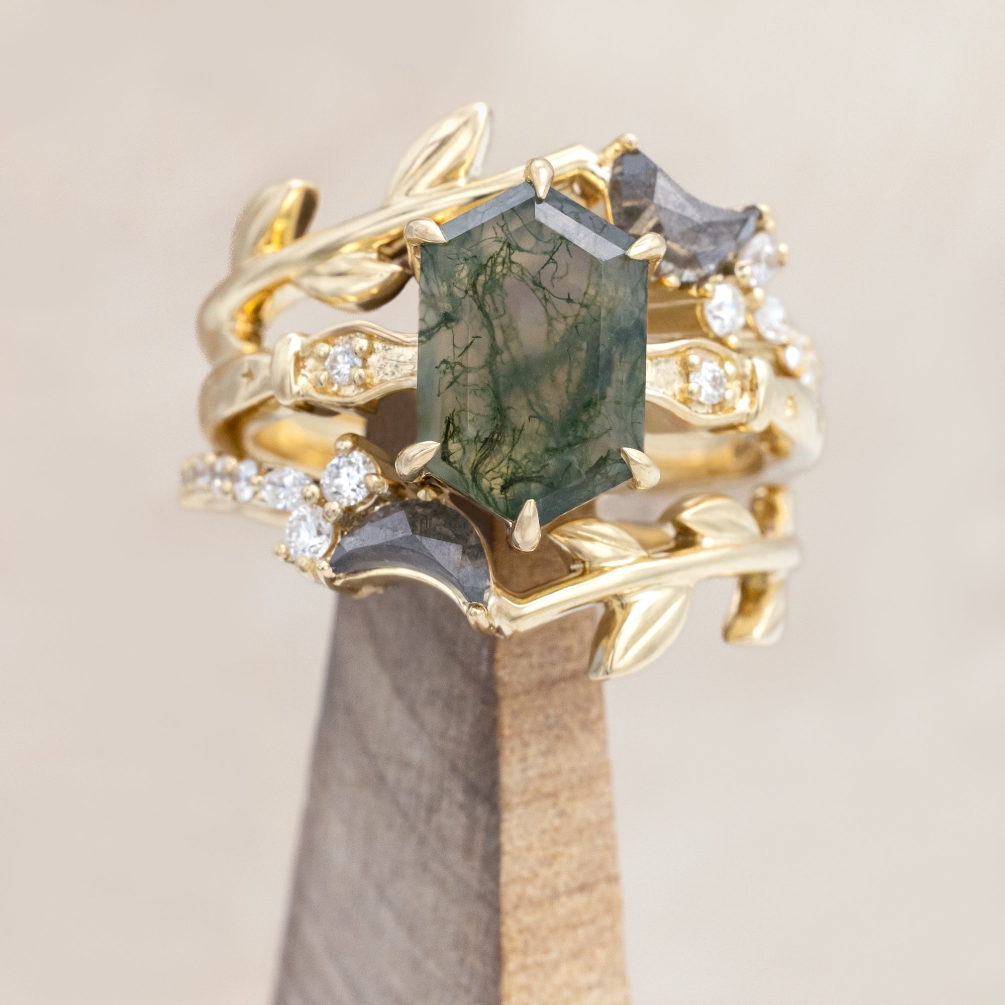 14K gold ring with a moss agate and two salt & pepper diamond tracers on a neutral background