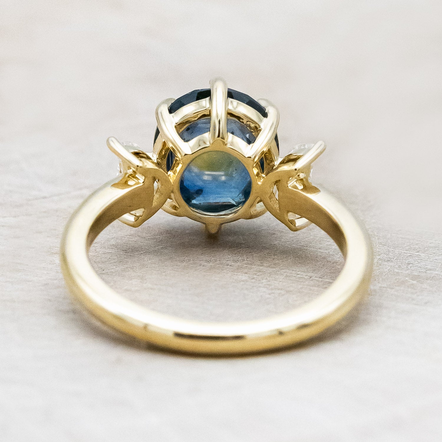 "Rhiannon" engagement ring with a portrait cut Montana sapphire and two crescent moon moissanite accents