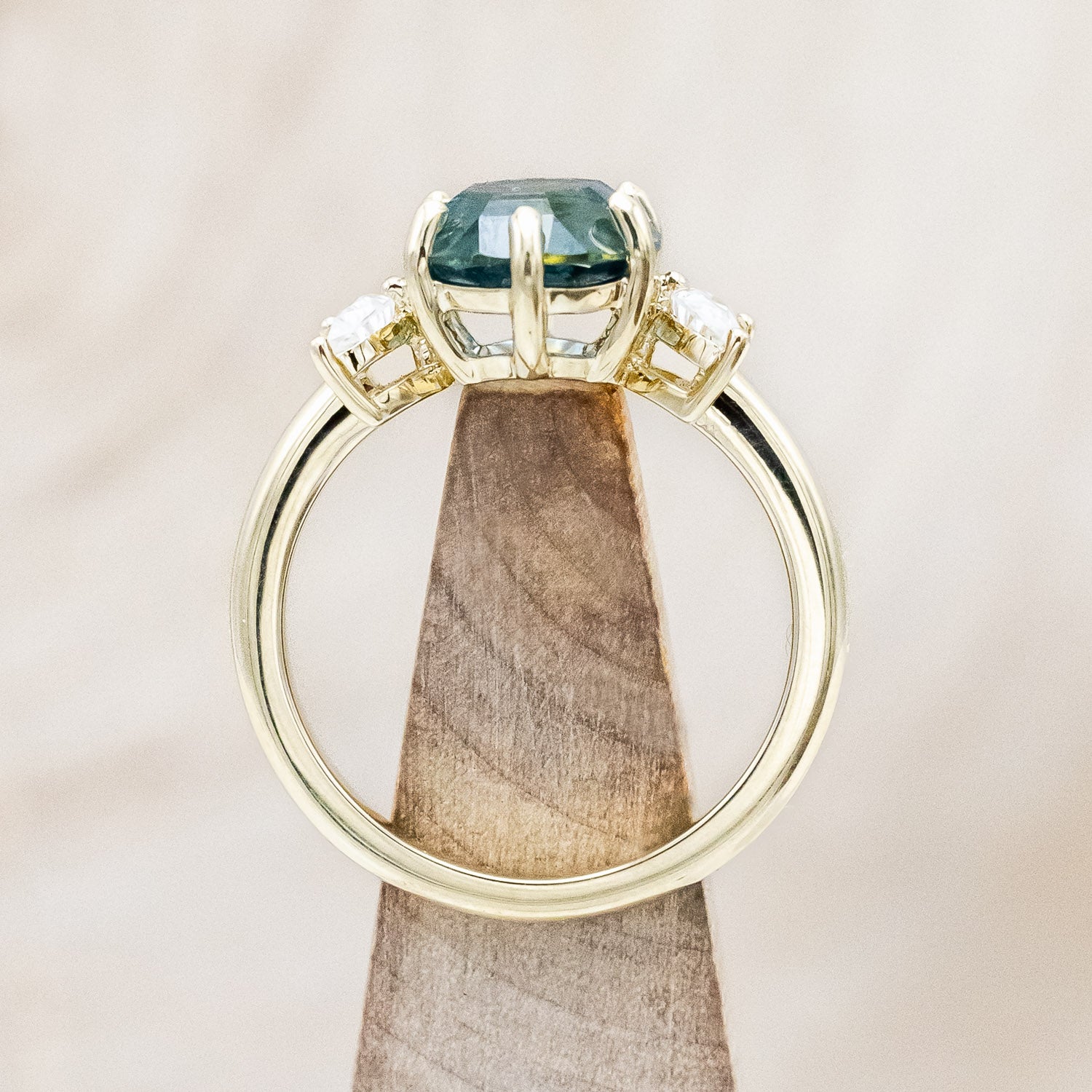 "Rhiannon" engagement ring with a portrait cut Montana sapphire and two crescent moon moissanite accents