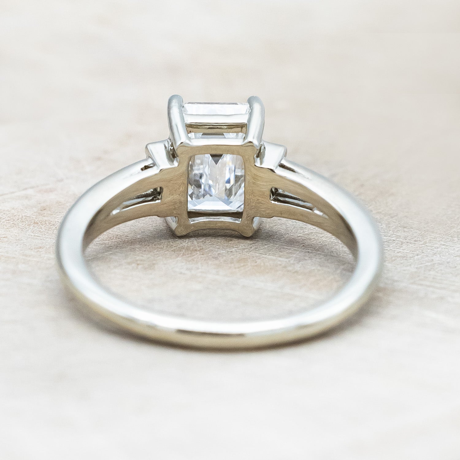 Back view of "Corella" - emerald cut lab-grown diamond women's engagement ring with diamond accents