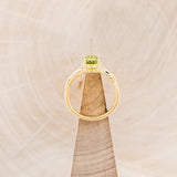 "HOPE" - ROUND CUT PERIDOT SOLITAIRE ENGAGEMENT RING WITH FEATHER ACCENTS