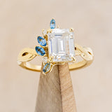 "GABRIELLA" - EMERALD CUT MOISSANITE ENGAGEMENT RING WITH AQUAMARINE ACCENTS IN A TWISTED BAND-1