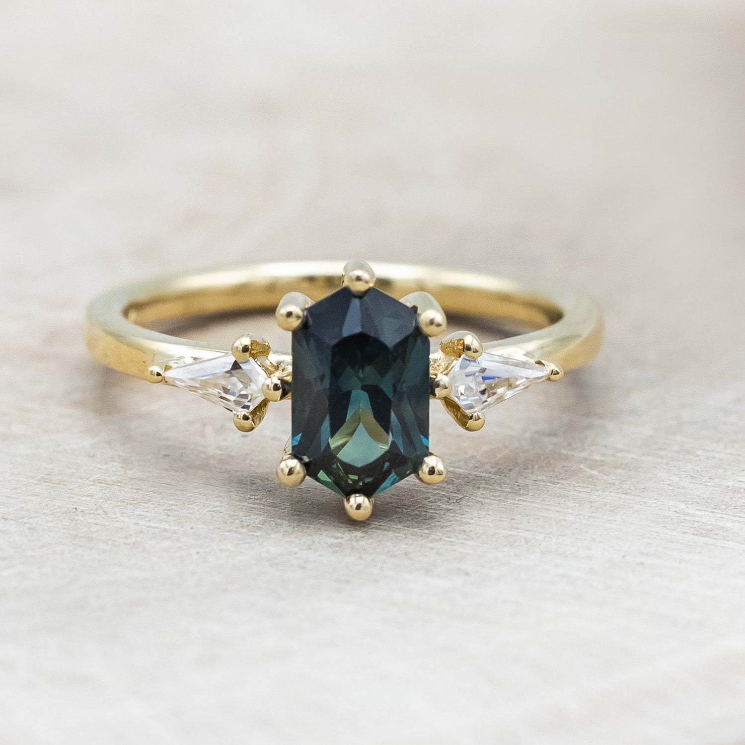"Isla" - elongated hexagon cut Australian sapphire with moissanite accents in 14K yellow gold