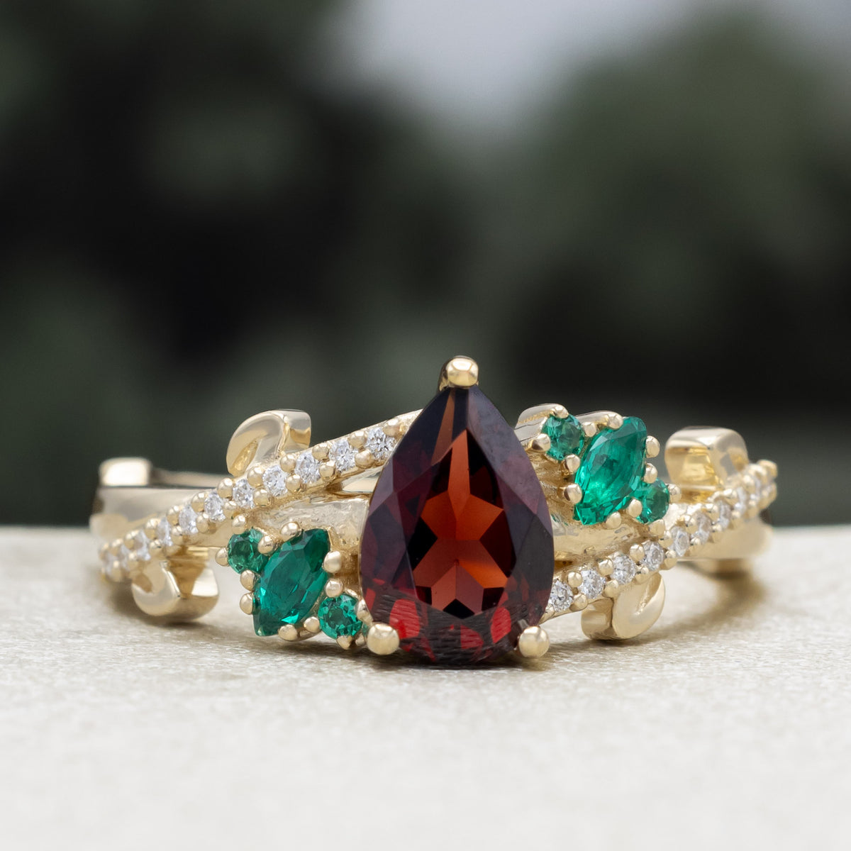 "Kamila" - Pear Cut Mozambique Garnet Engagement Ring With Lab-Grown Emerald & Diamond Accents-Staghead Designs