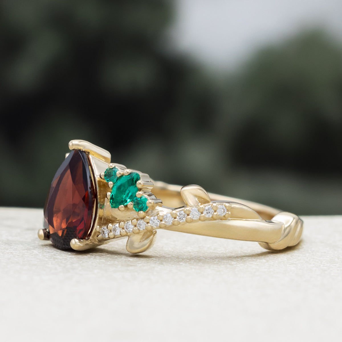 "Kamila" - Pear Cut Mozambique Garnet Engagement Ring With Lab-Grown Emerald & Diamond Accents-Staghead Designs
