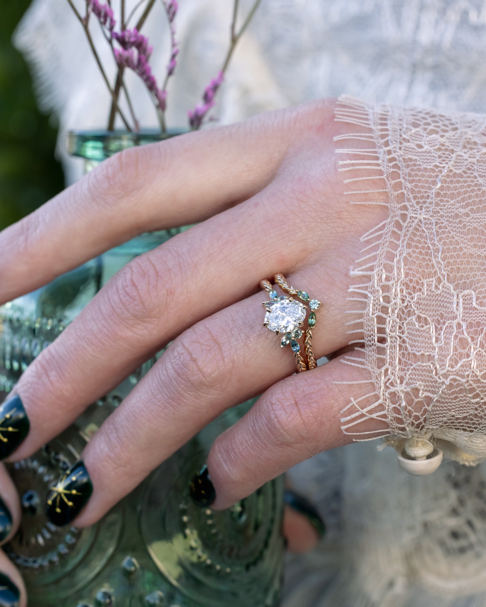 Close-up of a hand wearing a ring with a decorative background