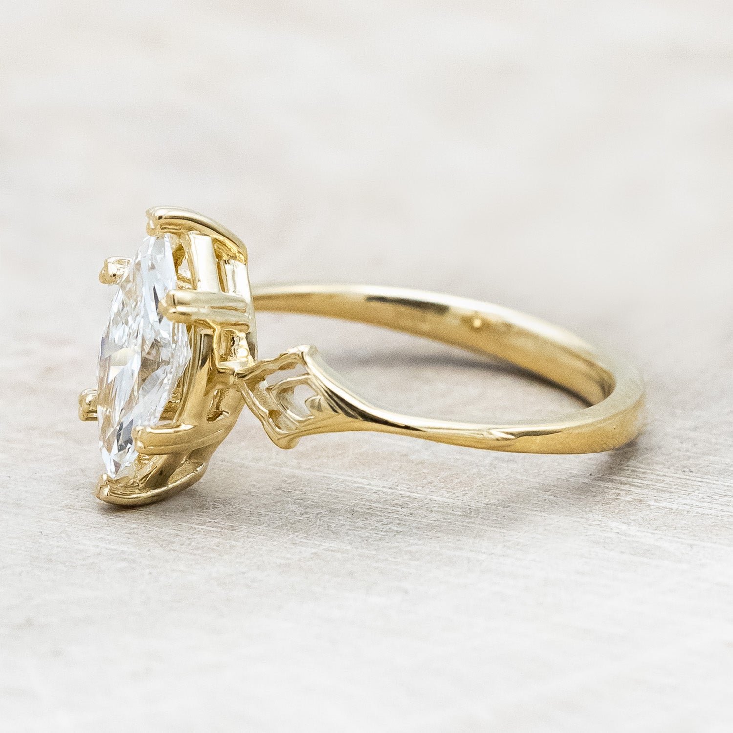 Side angle of "Morrigan" - ornate solitaire engagement ring with white marquise diamond