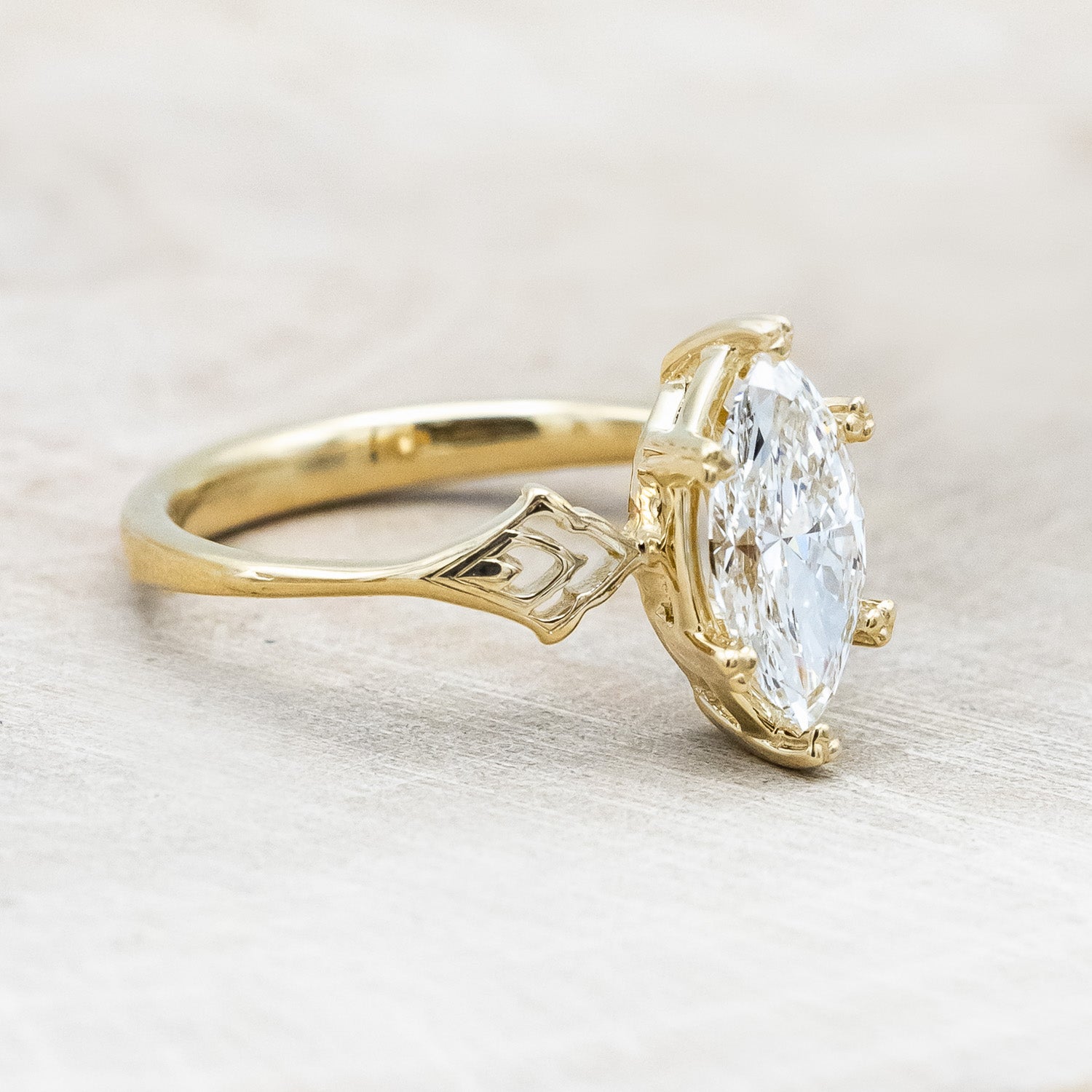 Side angle of "Morrigan" - ornate solitaire engagement ring with white marquise diamond