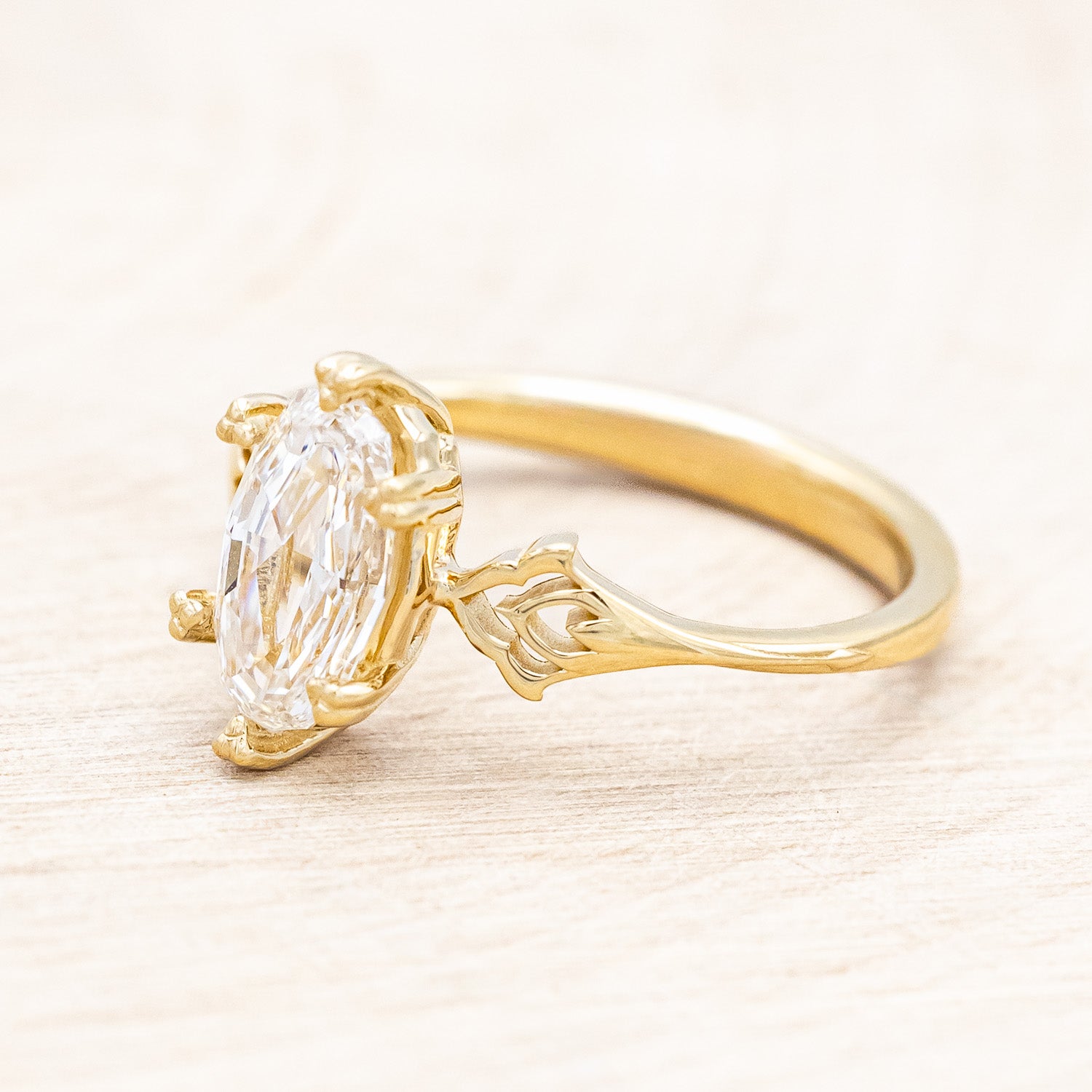 Side view of "Morrigan" - solitaire geo-cut diamond women's engagement ring on an ornate 14K yellow gold band