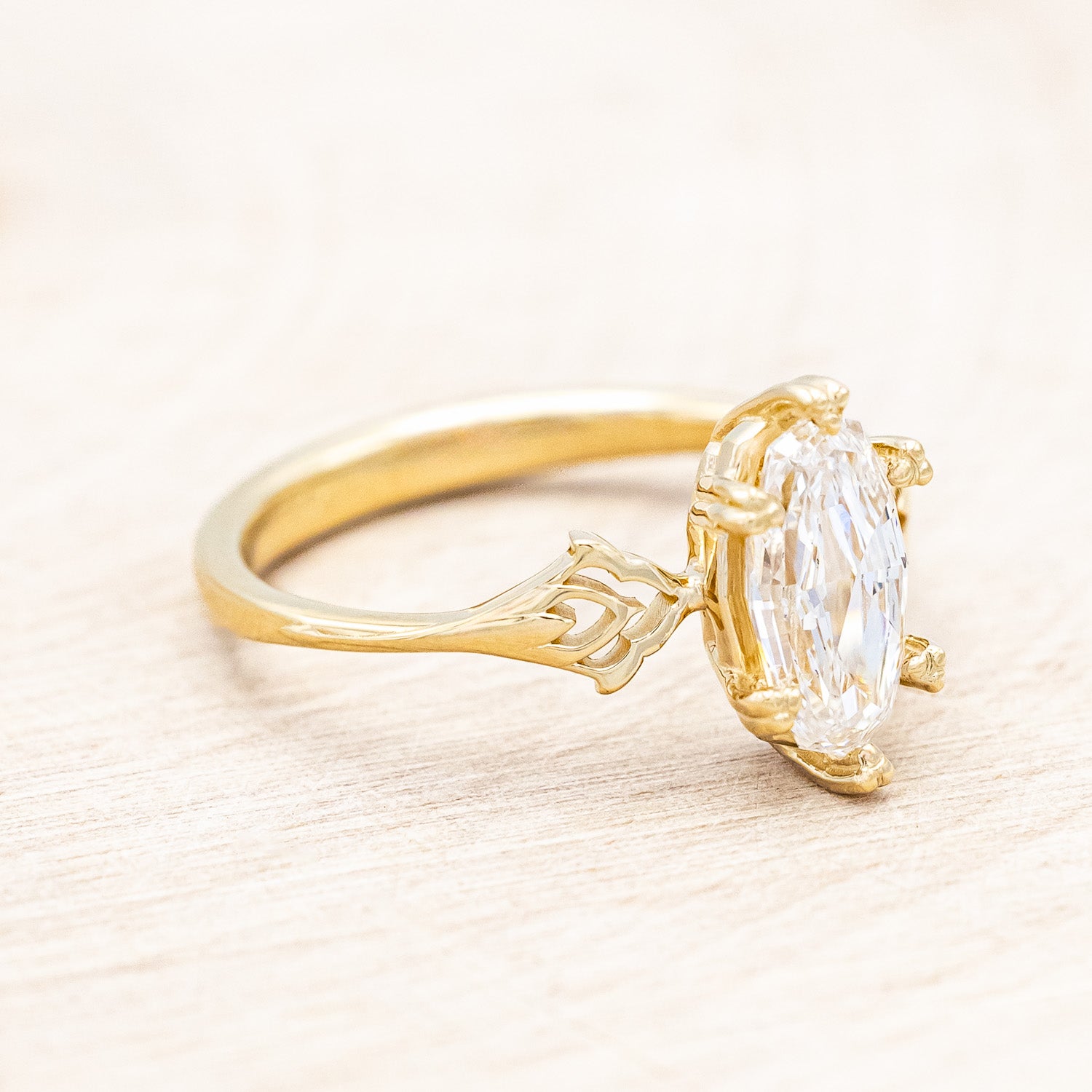 Side view of "Morrigan" - solitaire geo-cut diamond women's engagement ring on an ornate 14K yellow gold band
