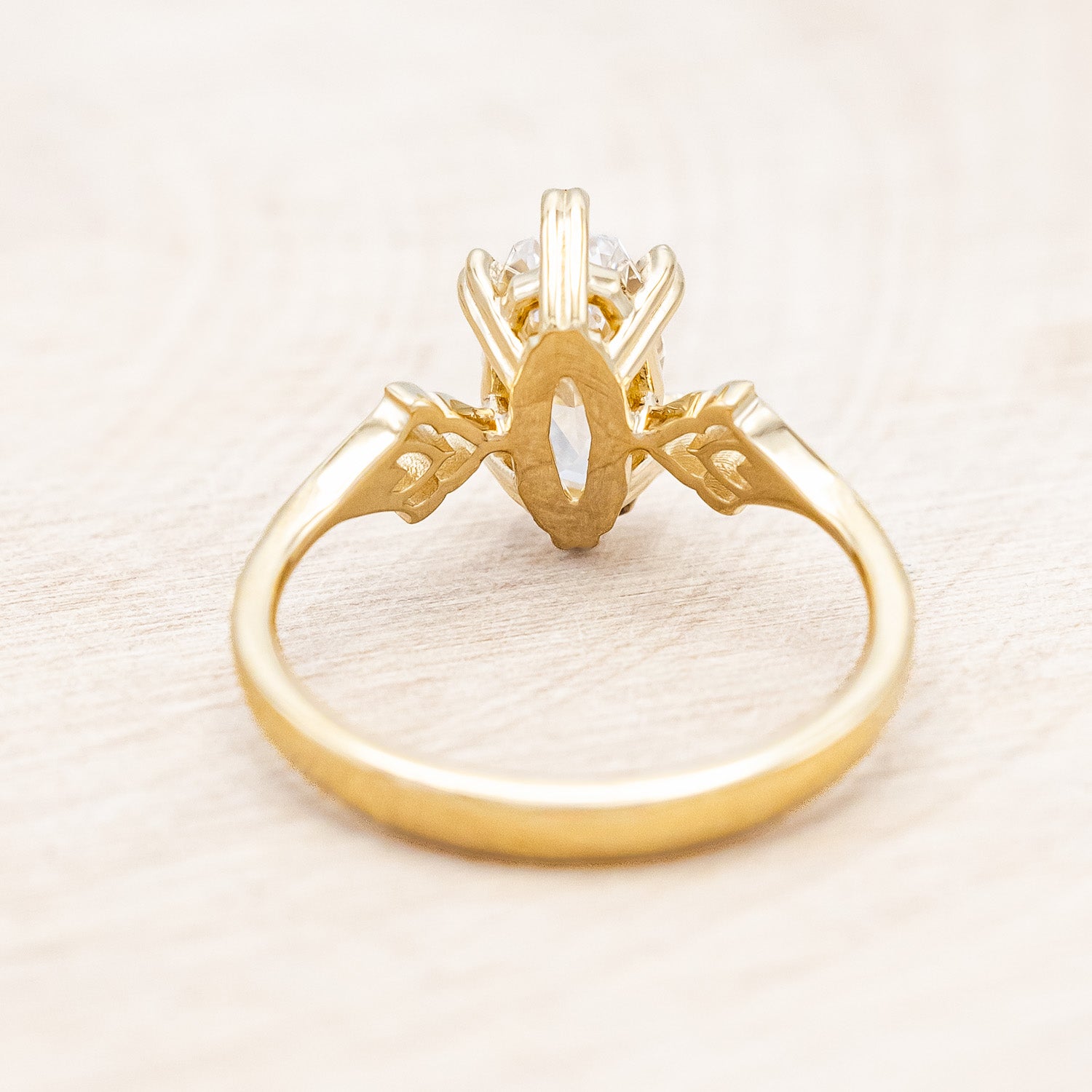 Back view of "Morrigan" - solitaire geo-cut diamond women's engagement ring on an ornate 14K yellow gold band