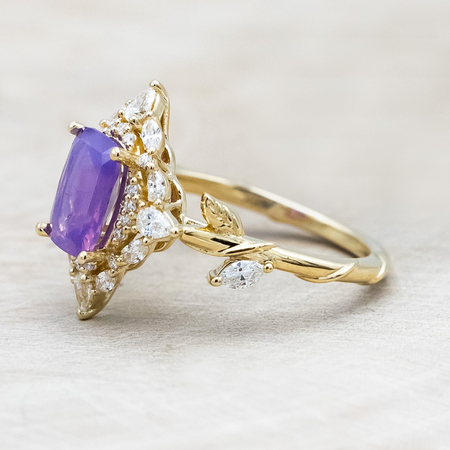 Side view of "Polaris" - women's engagement ring with a Sri Lanka opalescent sapphire, diamond halo & accents on a 14K yellow gold band.