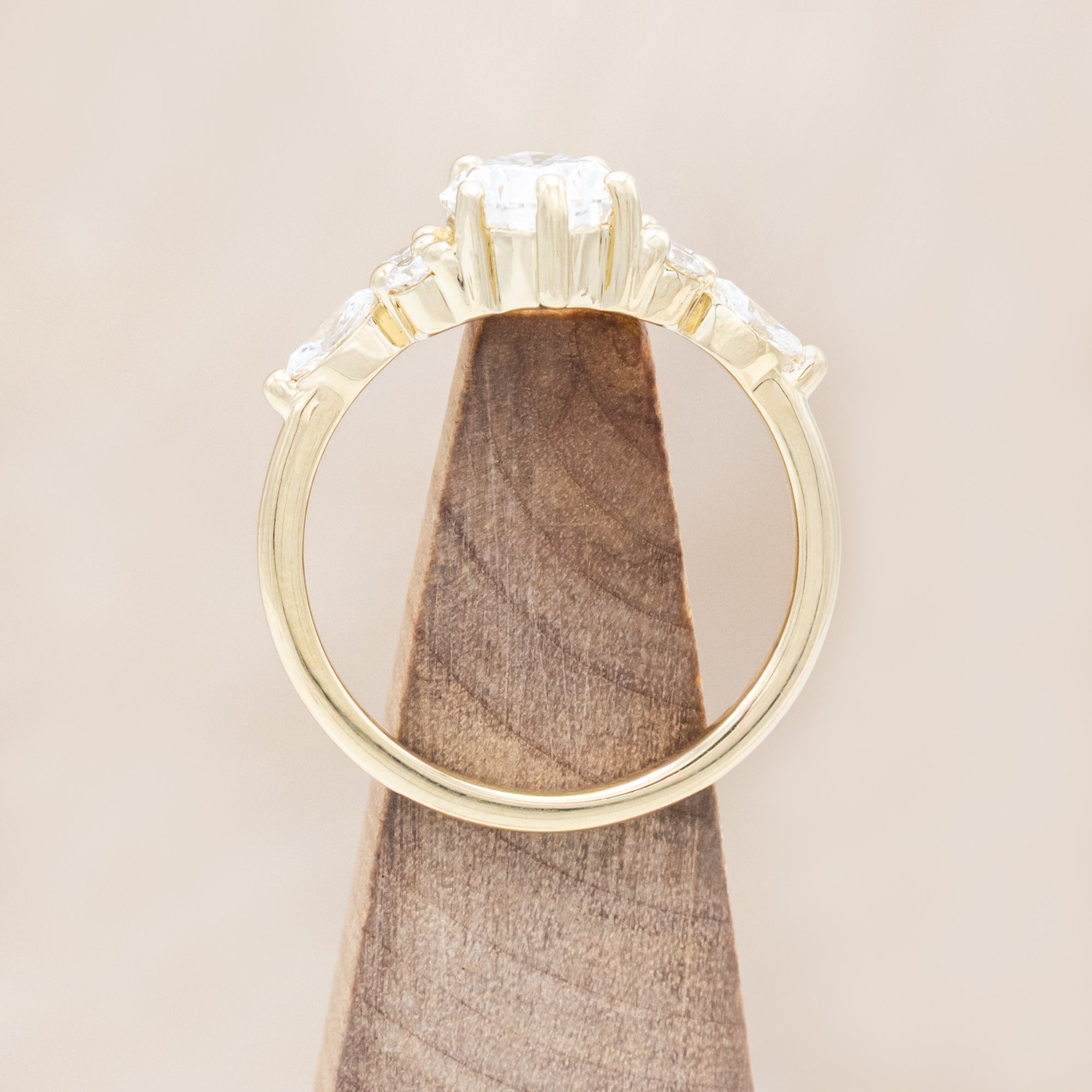 14K gold ring with a pear-cut lab diamond on a neutral background