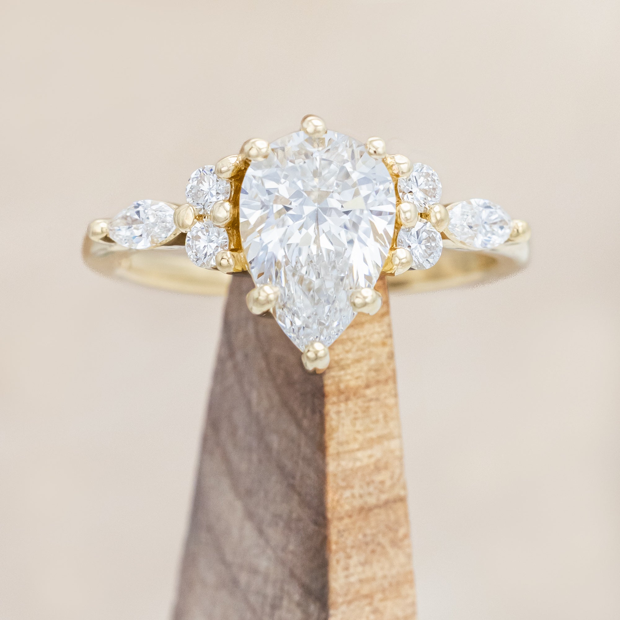 14K gold ring with a pear-cut lab diamond on a neutral background