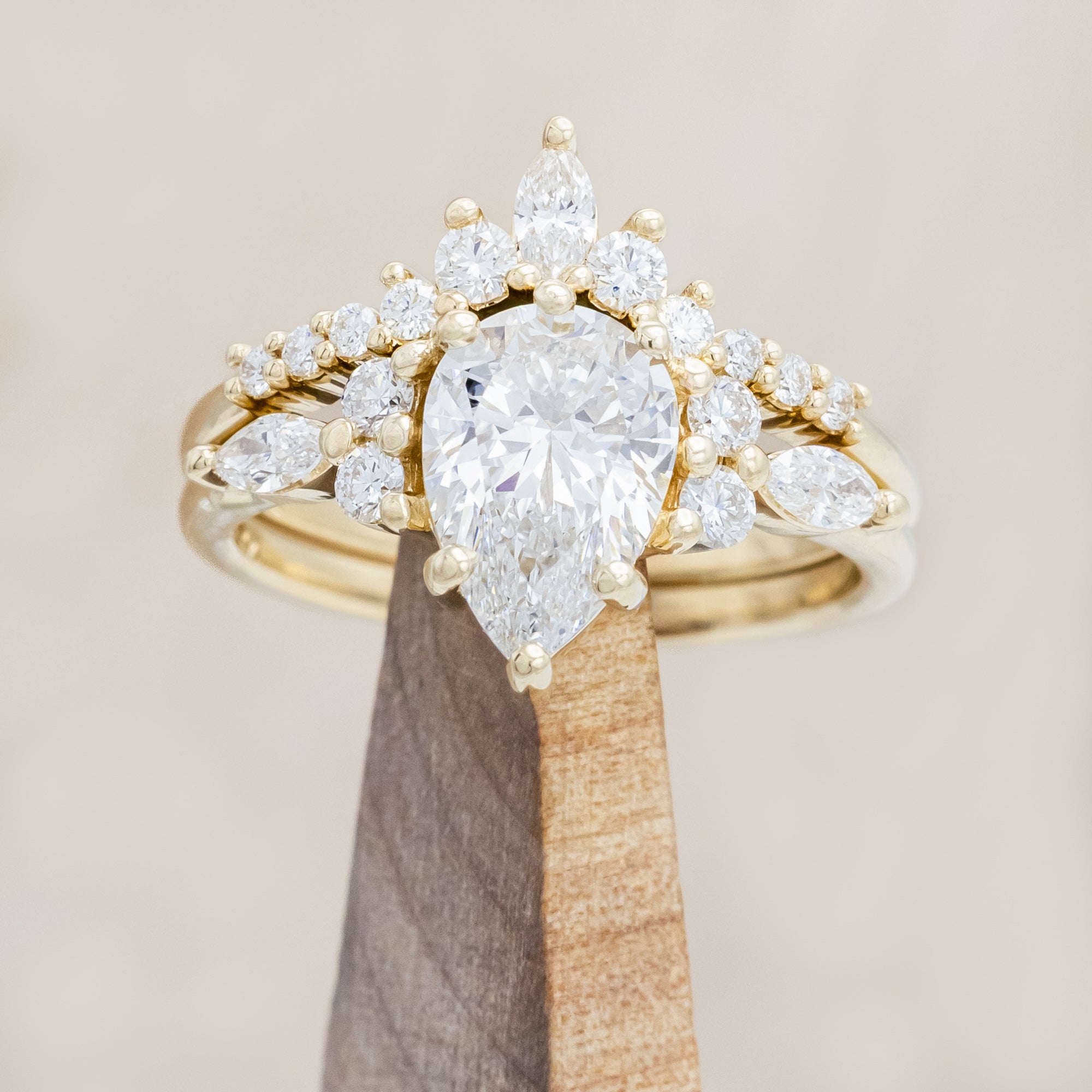 14K gold ring with a pear-cut lab diamond on a neutral background