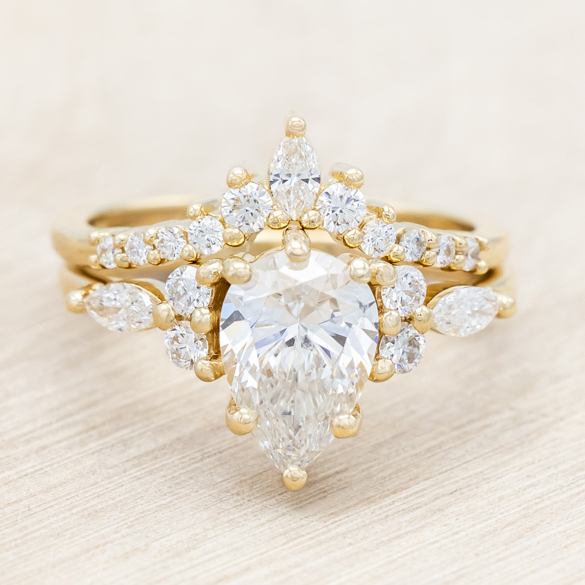 14K gold ring with a pear-cut lab diamond on a neutral background