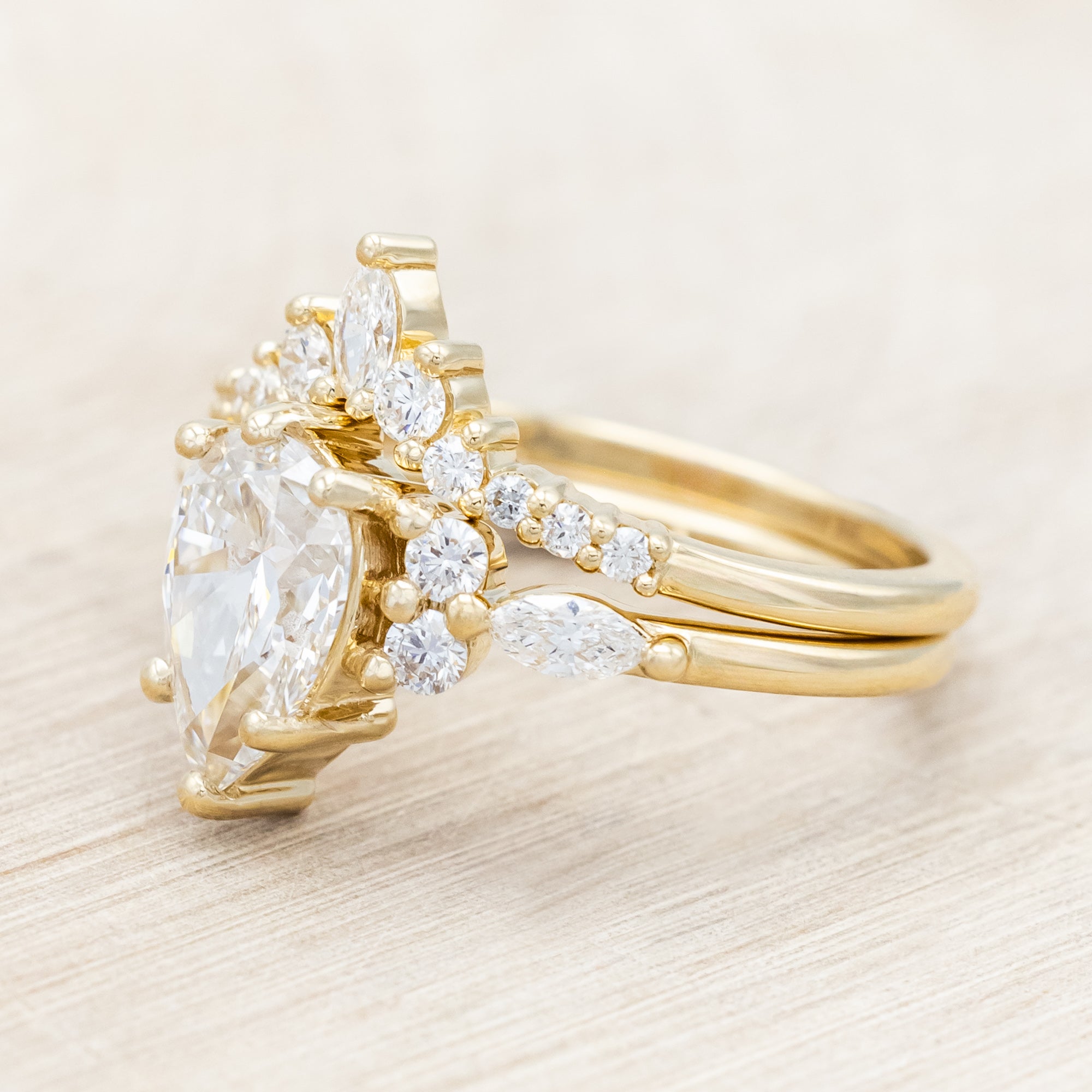 14K gold ring with a pear-cut lab diamond on a neutral background