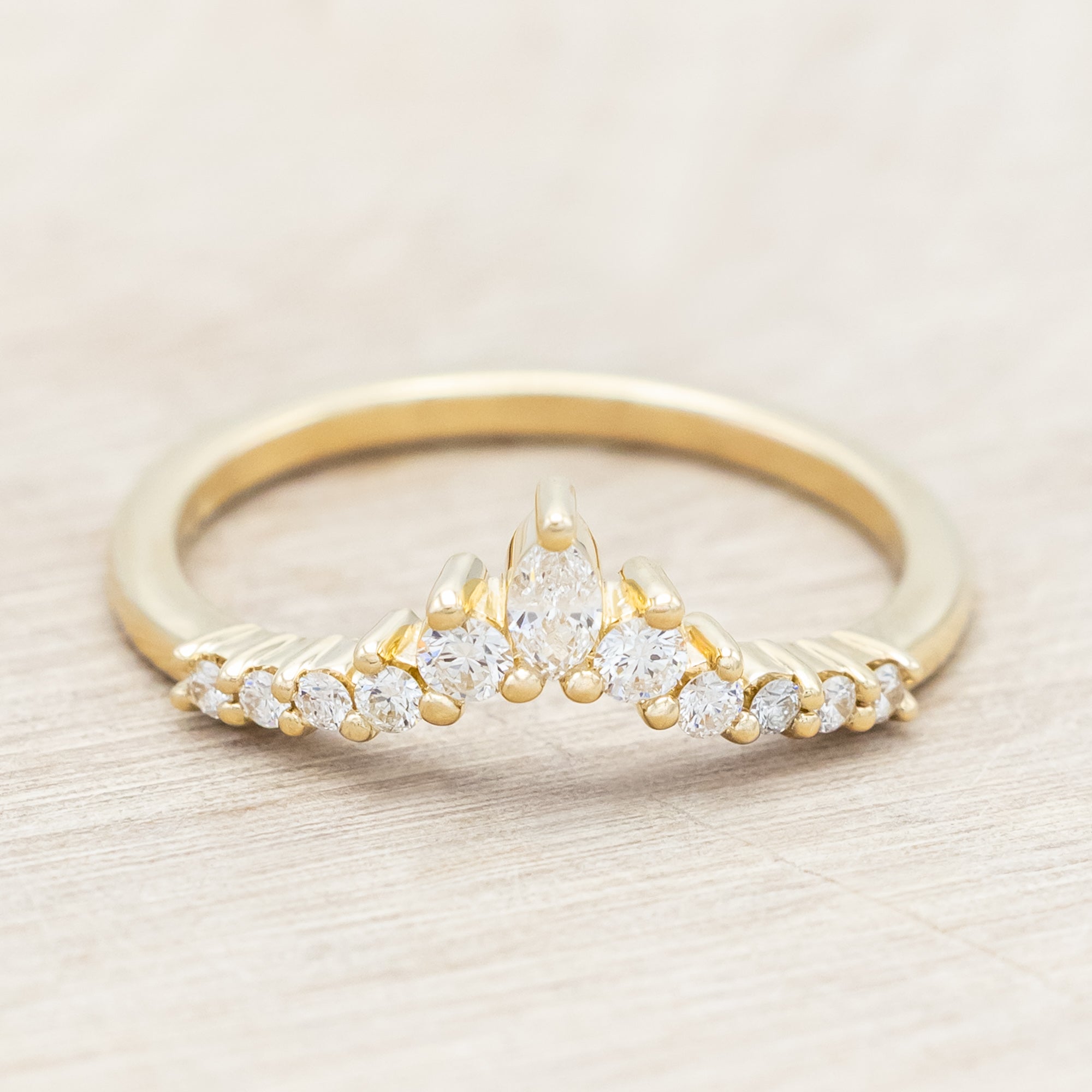 14K gold ring with diamond accents on a neutral background