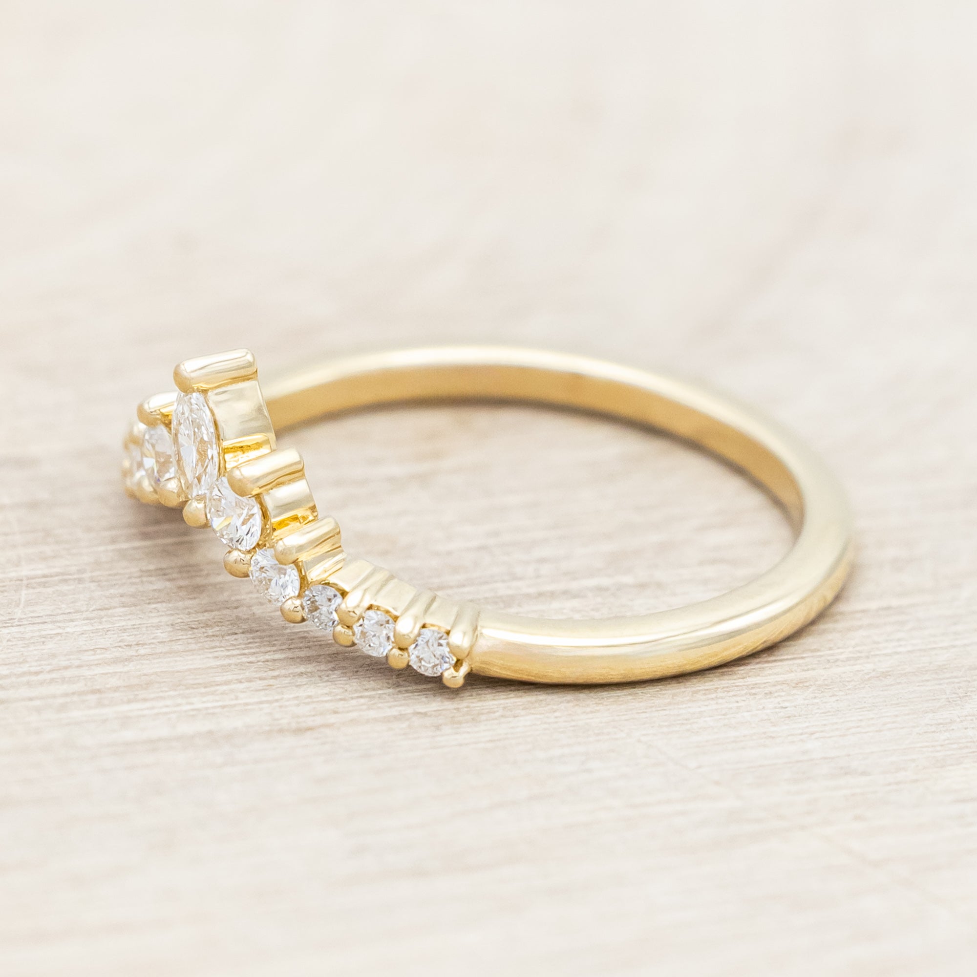 14K gold ring with diamond accents on a neutral background