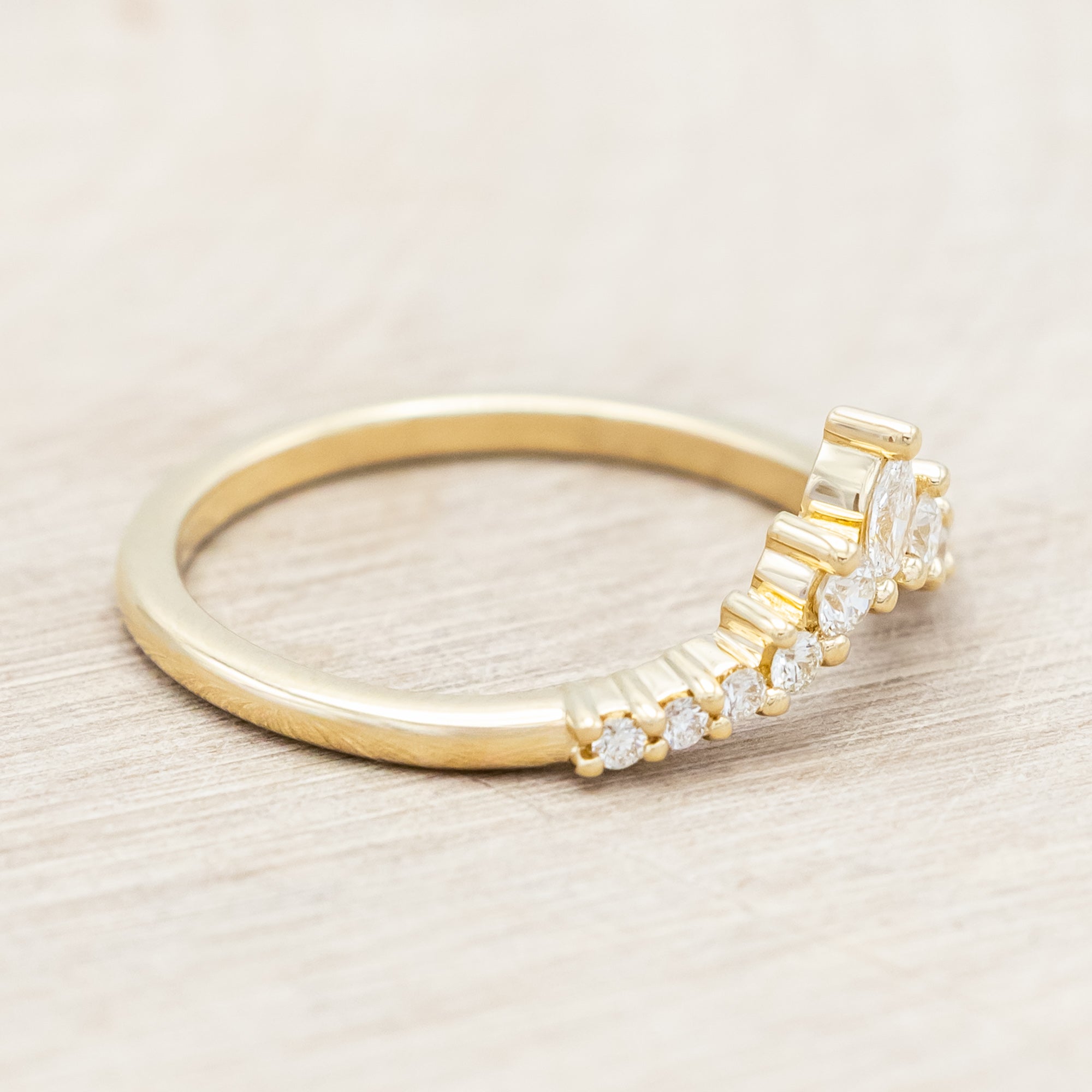 14K gold ring with diamond accents on a neutral background