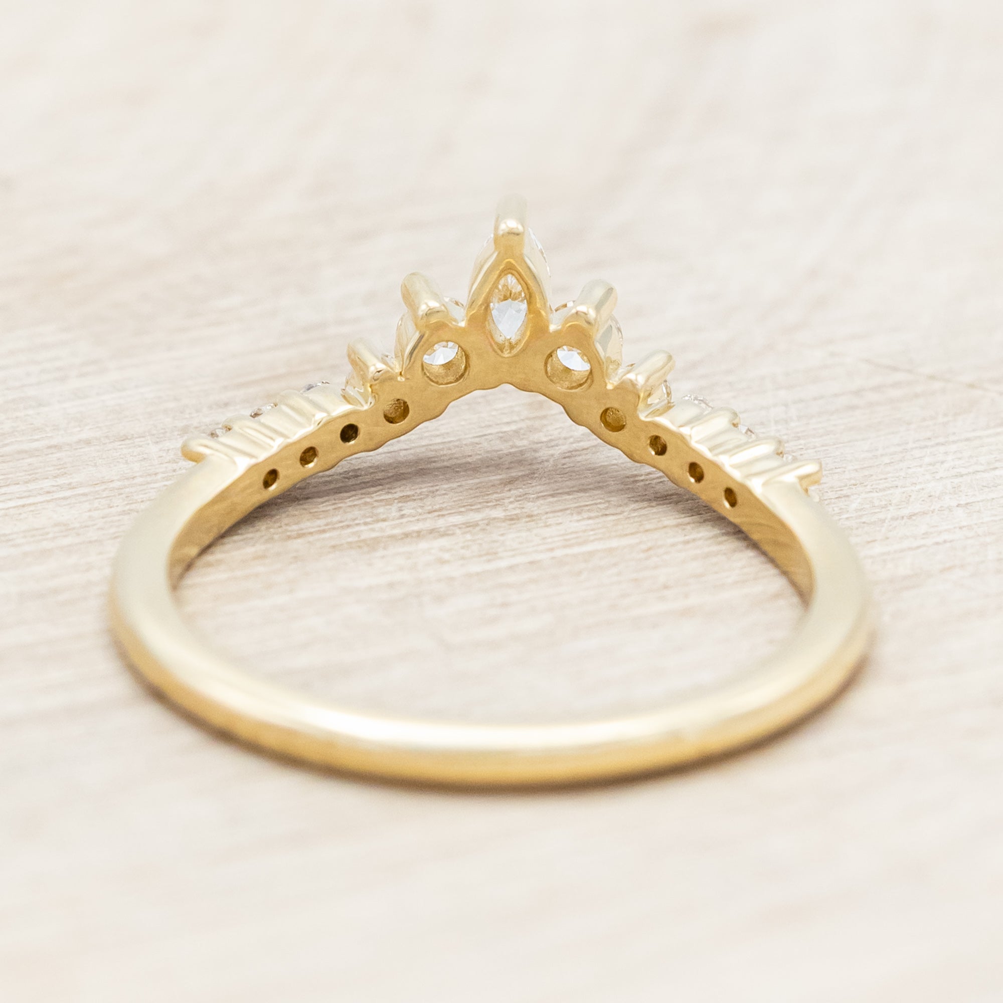 14K gold ring with diamond accents on a neutral background