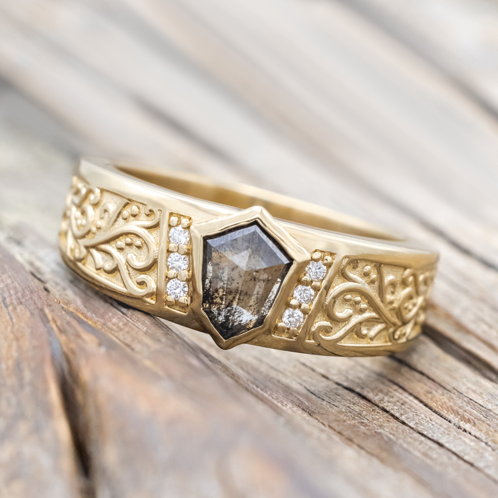 14K yellow gold ring with salt & pepper diamond and diamond accents on a wooden surface