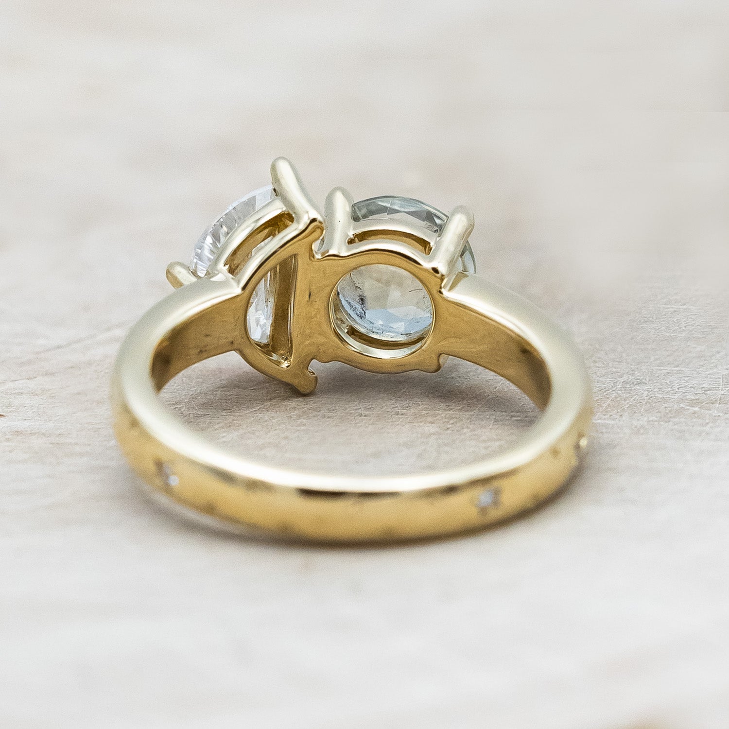 Back view of "Sidra" - toi et moi round cut green prasiolite women's engagement ring with a crescent moon moissanite accent