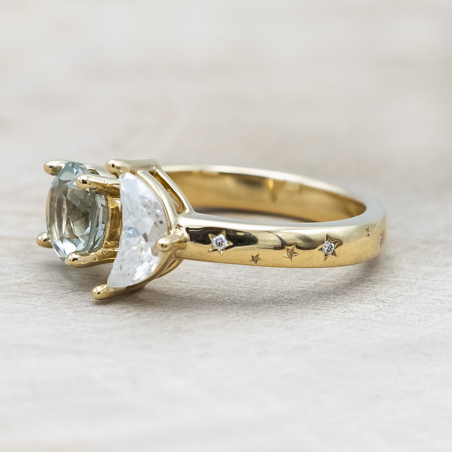 Side view of "Sidra" - toi et moi round cut green prasiolite women's engagement ring with a crescent moon moissanite accent