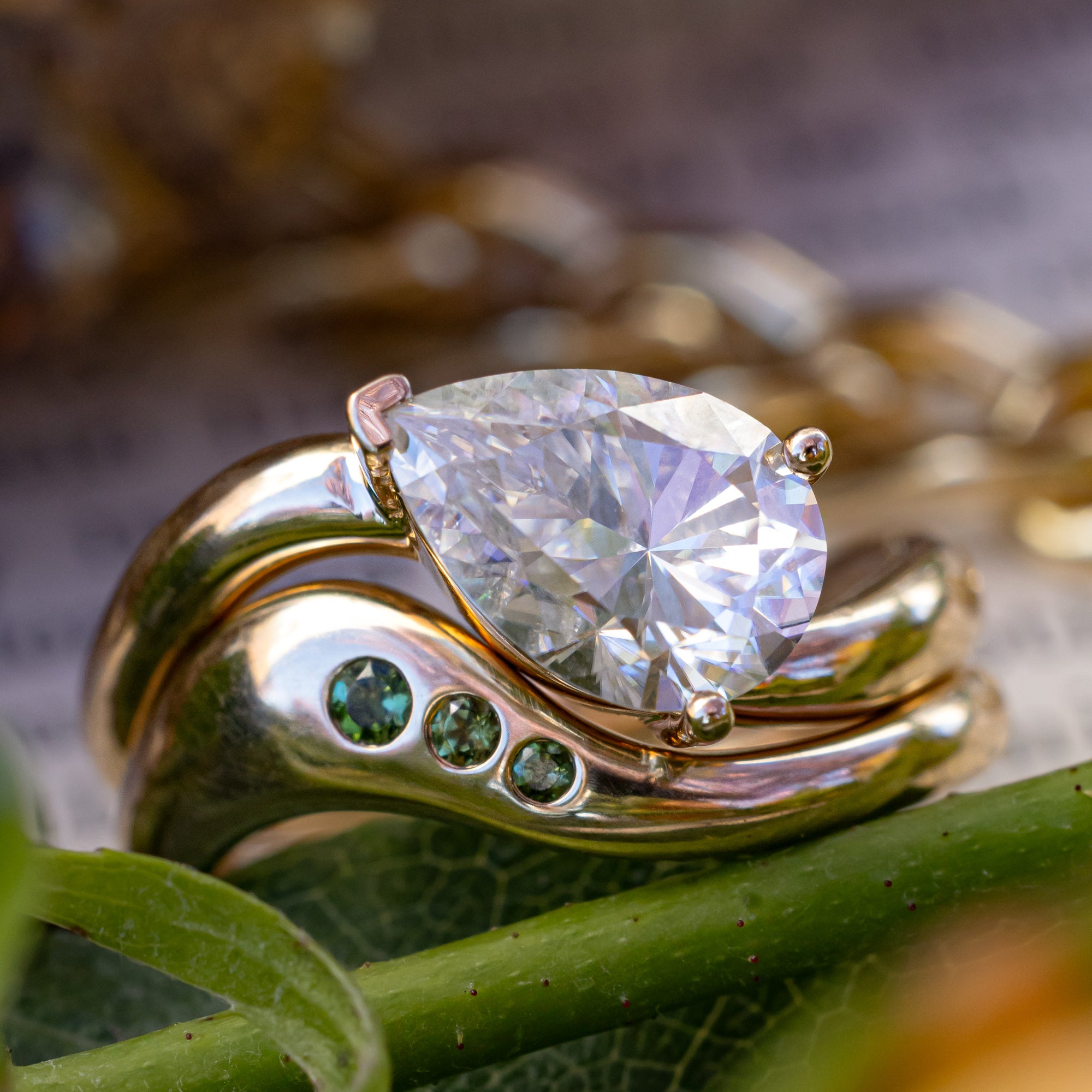 "SYBIL" - PEAR CUT MOISSANITE ASYMMETRICAL ENGAGEMENT RING WITH A GREEN TOURMALINE ACCENTED TRACER-Staghead Designs