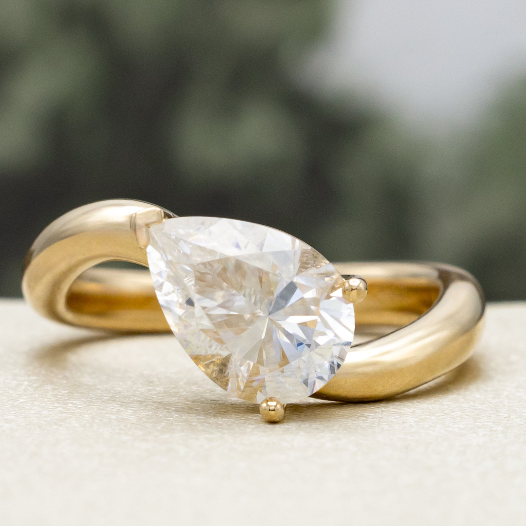 "SYBIL" - PEAR CUT MOISSANITE ASYMMETRICAL ENGAGEMENT RING WITH A GREEN TOURMALINE ACCENTED TRACER-Staghead Designs