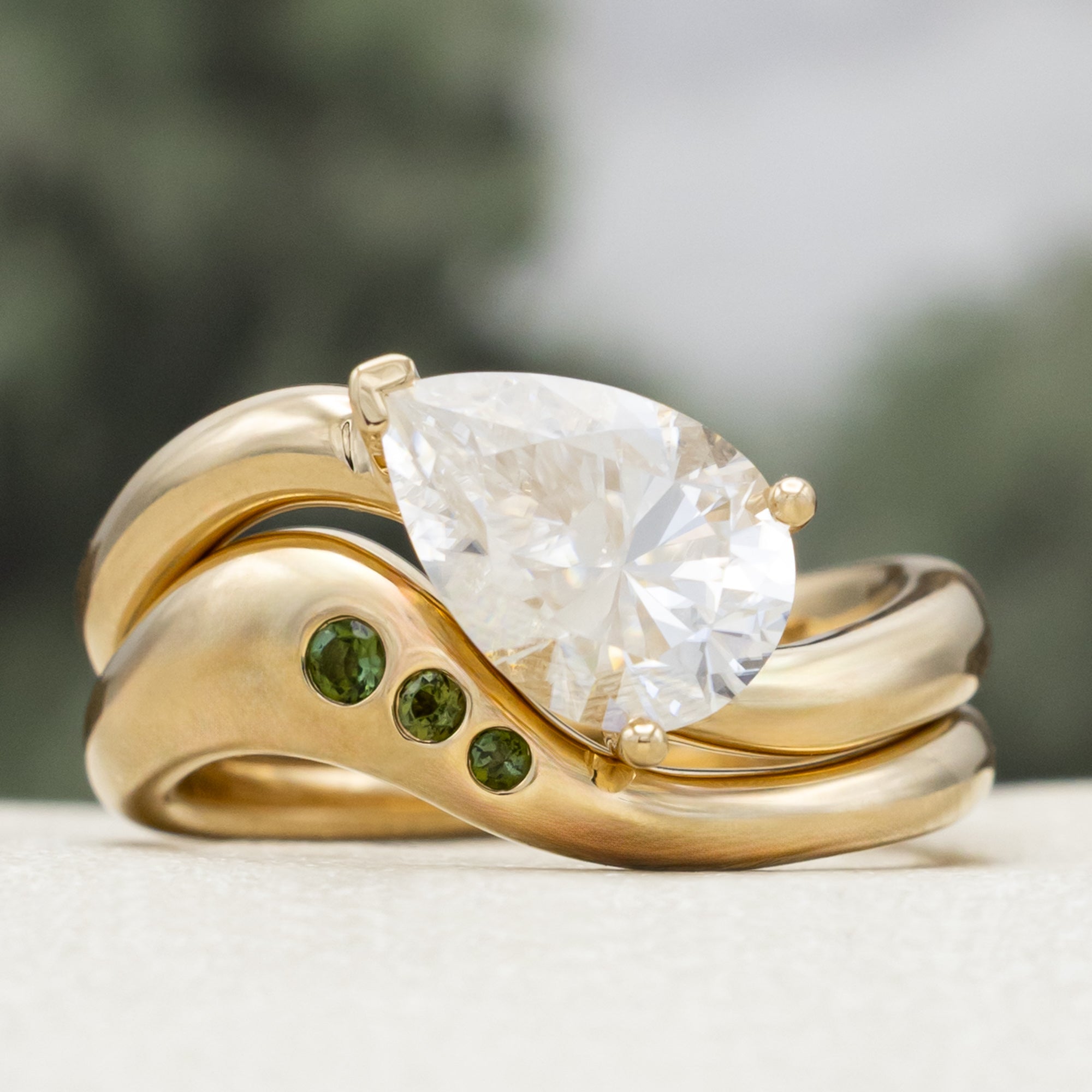 "SYBIL" - PEAR CUT MOISSANITE ASYMMETRICAL ENGAGEMENT RING WITH A GREEN TOURMALINE ACCENTED TRACER-Staghead Designs