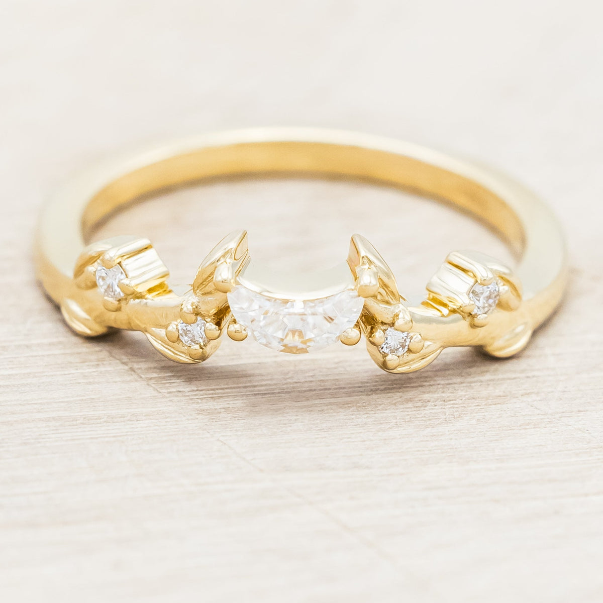 14K gold ring with diamond & moissanite accents on a beige background
