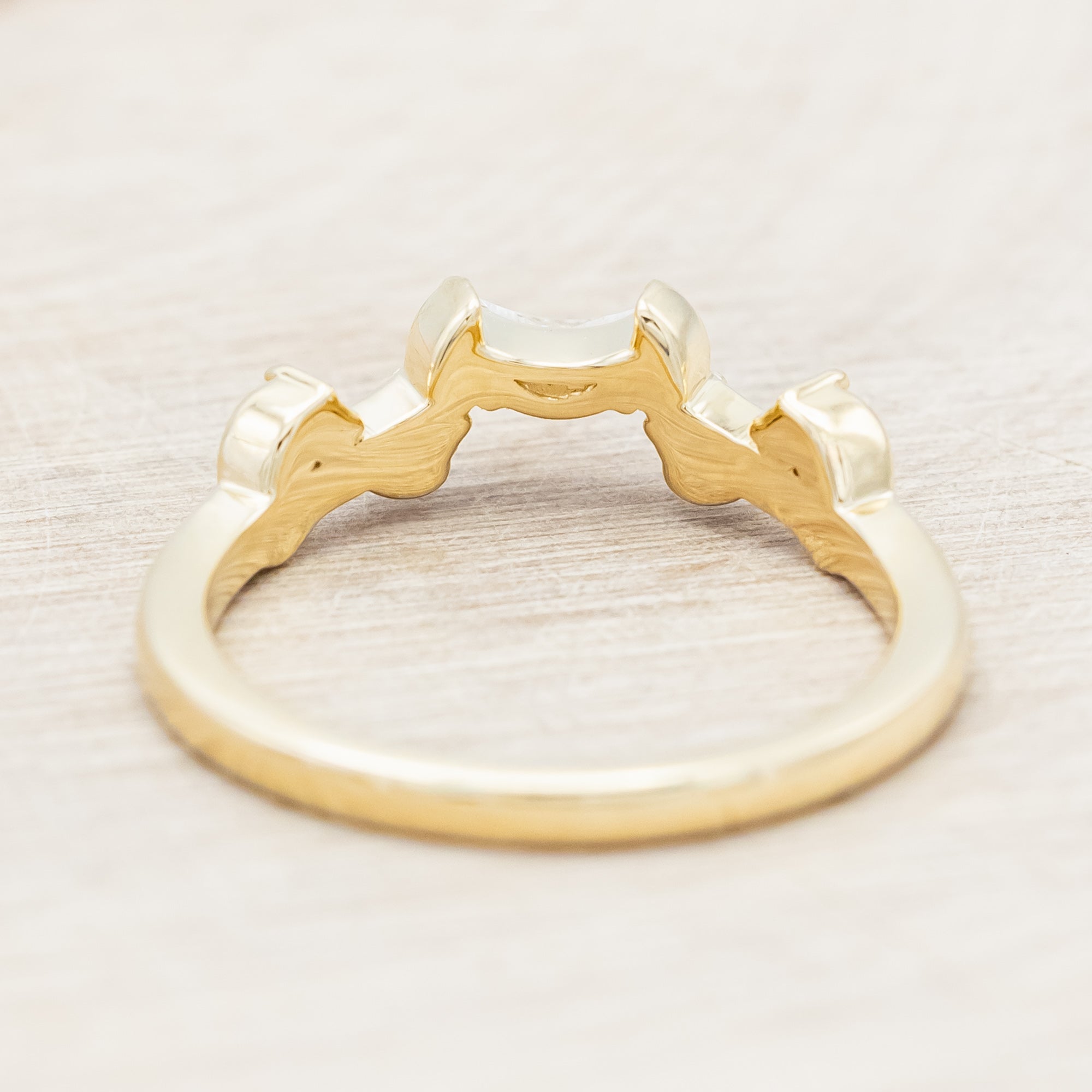 14K gold ring with diamond & moissanite accents on a beige background