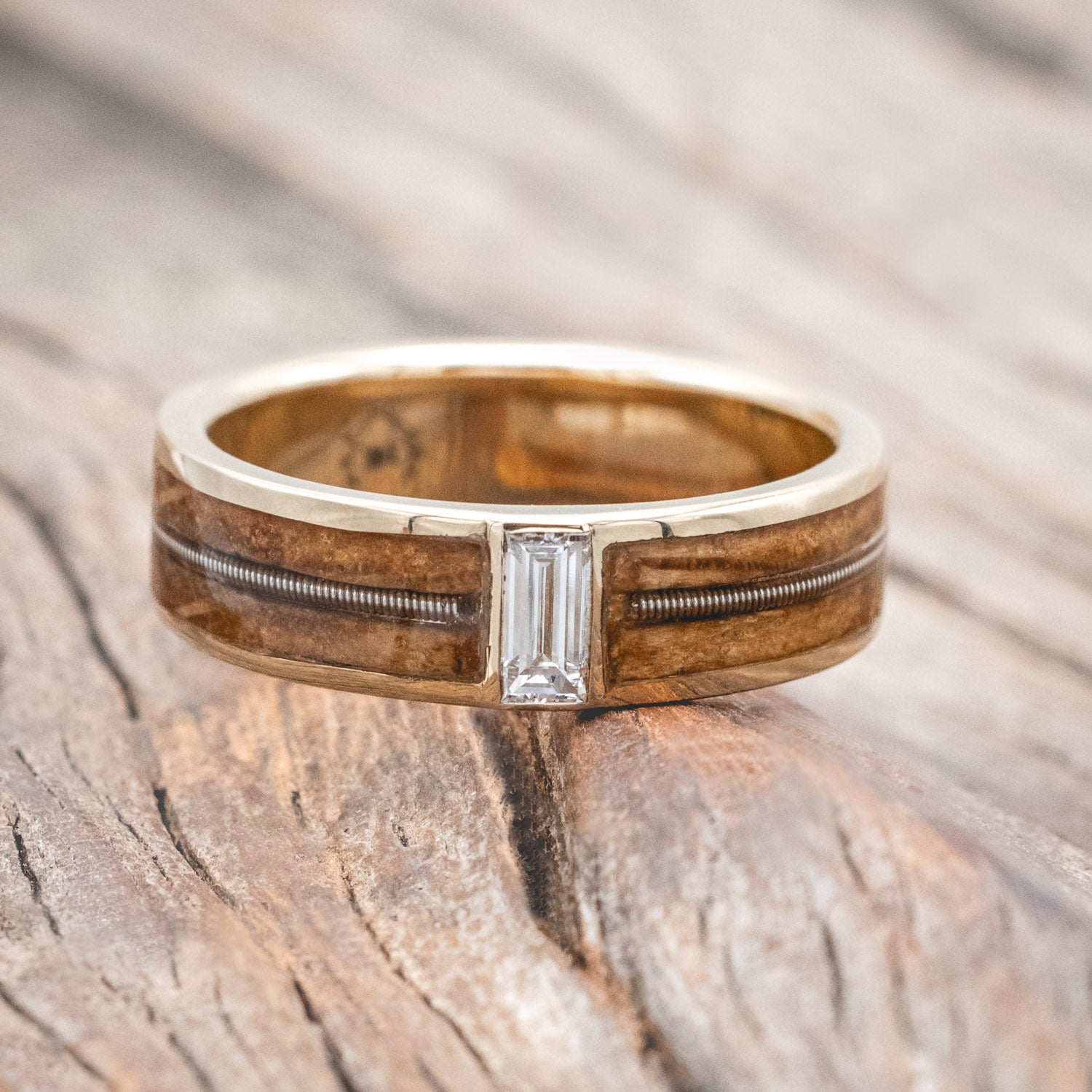 "Vaughan" Men's Wedding Ring with whiskey barrel oak inlays divided by a guitar string & lab-grown baguette cut diamond. 
