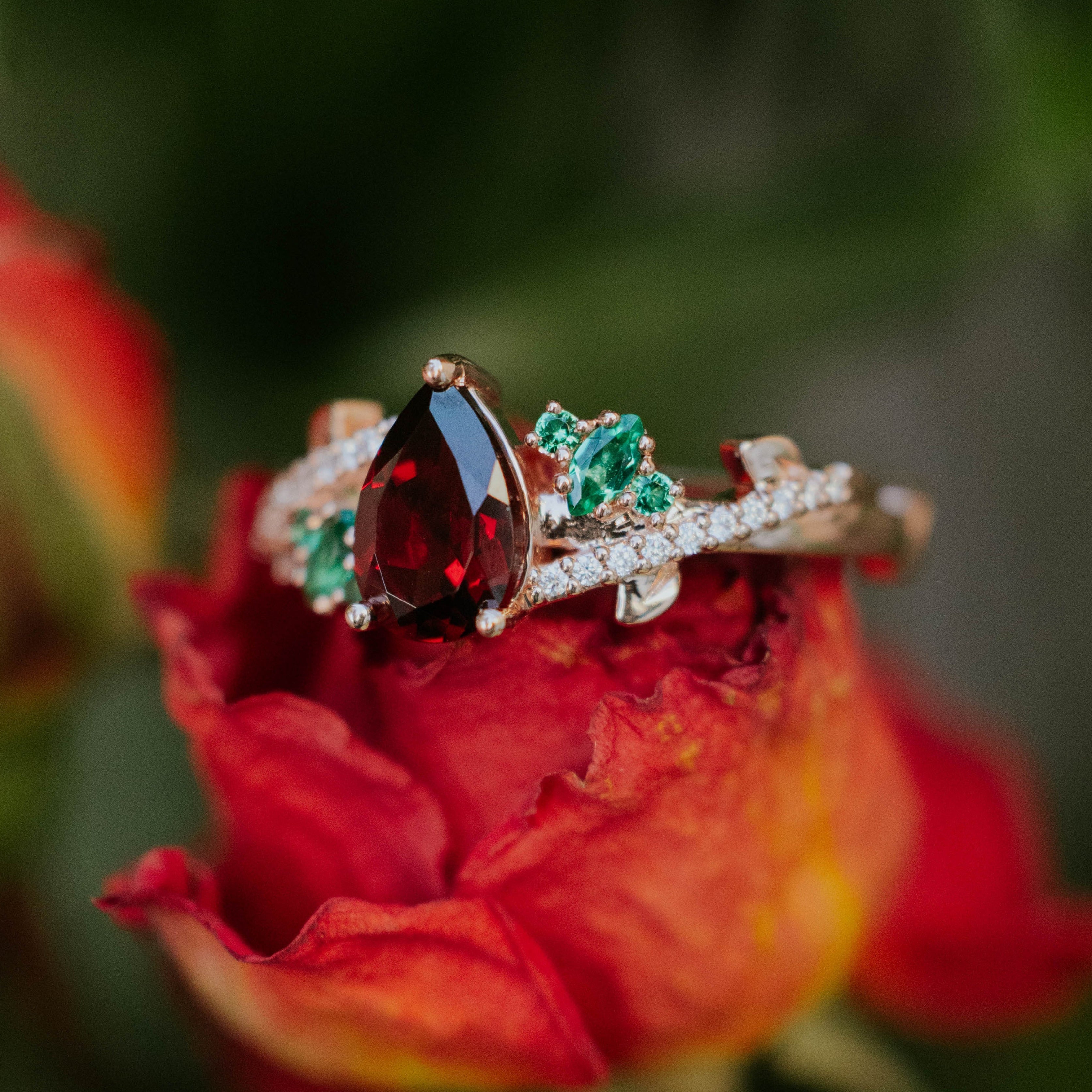 "KAMILA" - PEAR CUT MOZAMBIQUE GARNET ENGAGEMENT RING WITH LAB-GROWN EMERALD & DIAMOND ACCENTS-Staghead Designs