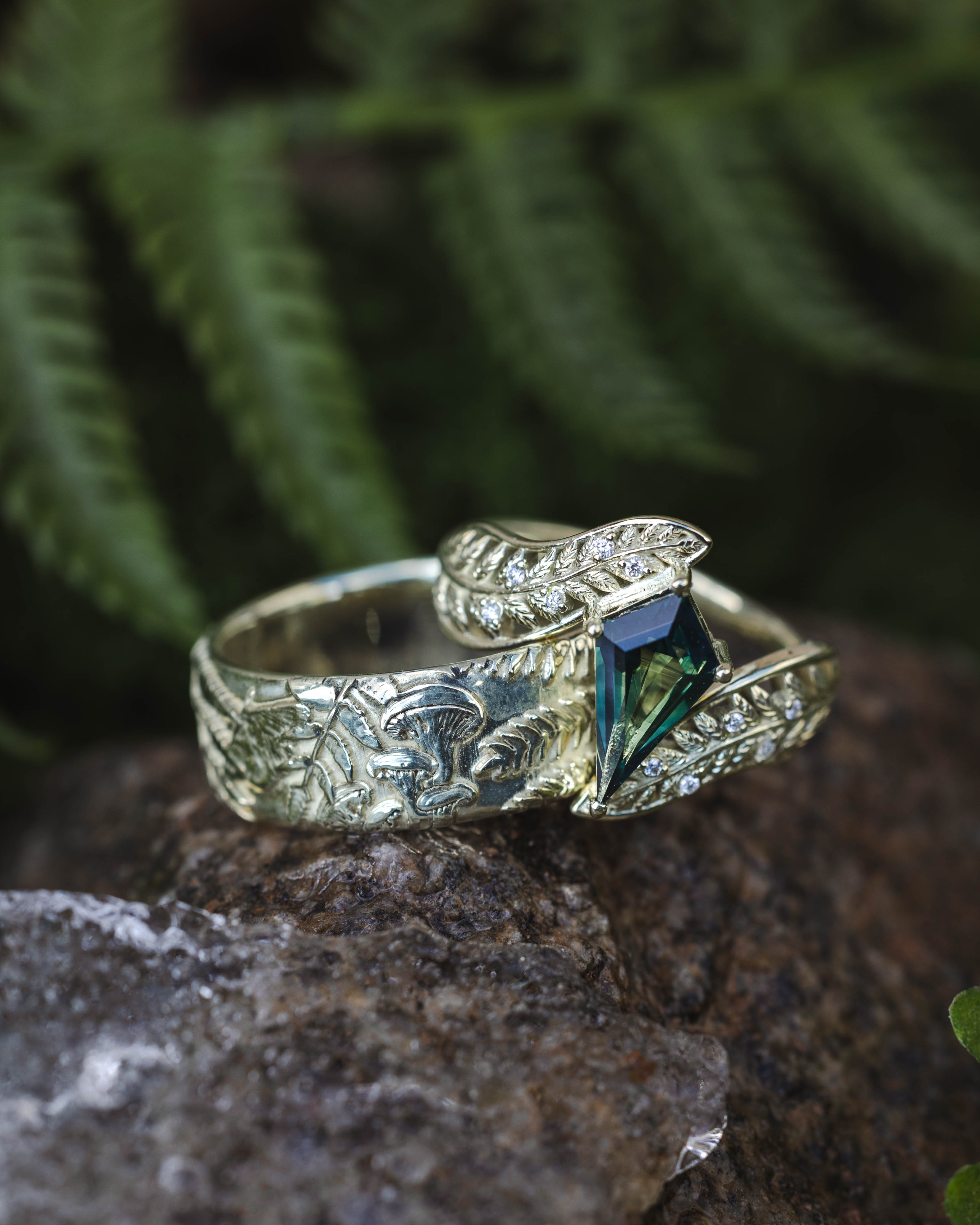 Green gold rings on a rock with ferns in the background