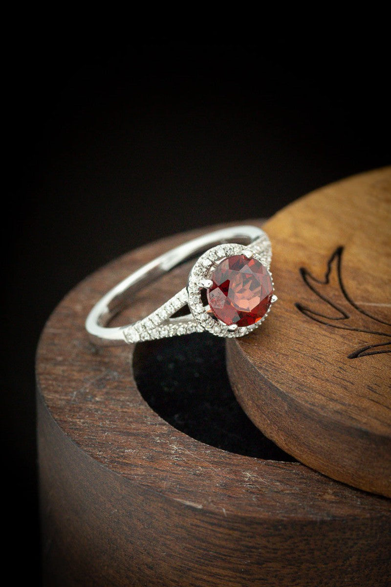 Shown here is The "Aura", a birthstone ring with a split shank-style & a garnet women's ring with delicate and ornate details and is available with many center stone options