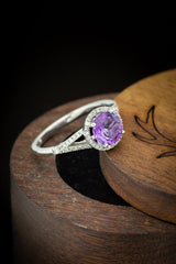 Shown here is The "Aura", a birthstone ring with a split shank-style Amethyst women's ring with delicate and ornate details and is available with many center stone options
