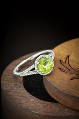 Shown here is  The "Aura", a birthstone ring with a split shank-style peridot women's ring with delicate and ornate details and is available with many center stone options