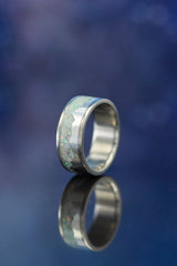 Shown here is "Helios", a custom, handcrafted men's wedding ring featuring a mountain range using pieces of silver and a crushed fire & ice Opal. Additional inlay options are available upon request.