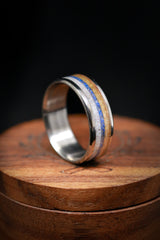 Shown here is "Rainier", a custom, handcrafted men's wedding ring featuring antler, lapis lazuli, and whiskey barrel oak, shown here on a single channel titanium band. Additional inlay options are available upon request.-Single Channel Wedding Band With Antler, Lapis Lazuli & Whiskey Barrel Inlays - Staghead Designs