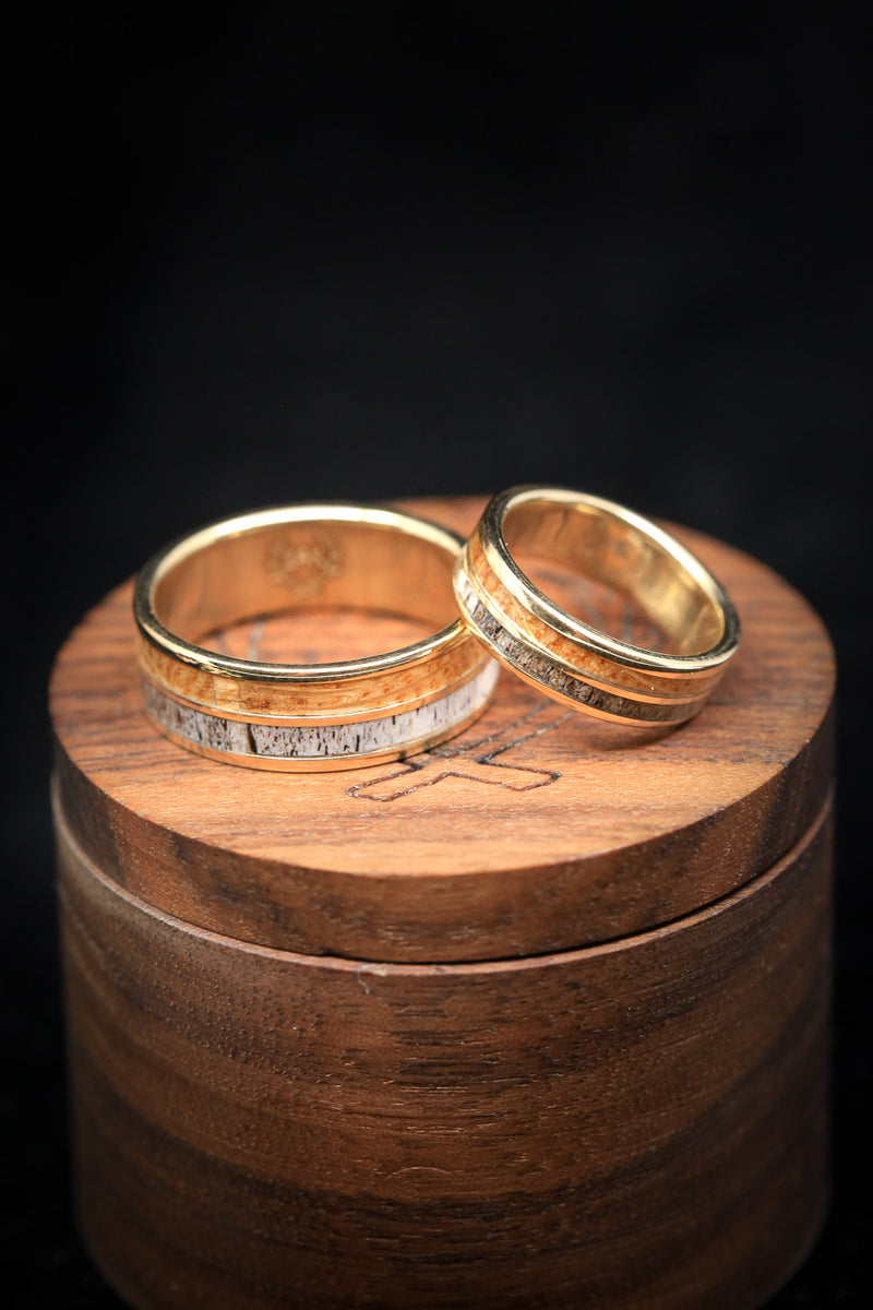 Shown here is "Dyad" matching set, a custom, handcrafted matching set of wedding rings featuring elk antler and whiskey barrel wood. Additional inlay options are available upon request.