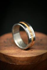 Shown here is a custom, handcrafted men's wedding ring featuring a Bethlehem olive wood and a 14K rose gold inlay. Additional inlay options are available upon request.-Damascus Steel Wedding Band With Spalted Maple & Gold Inlay - Staghead Designs