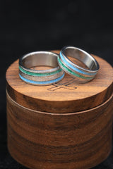 Shown here is Matching wedding band set featuring turquoise and malachite inlays set on hand-turned titanium, with a hammered center. Additional wood & inlay options are available upon request.