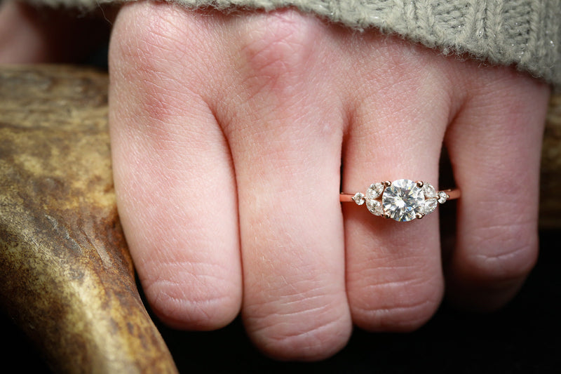 "BLOSSOM" - ROUND CUT MOISSANITE ENGAGEMENT RING WITH LEAF-SHAPED DIAMOND ACCENTS - READY TO SHIP